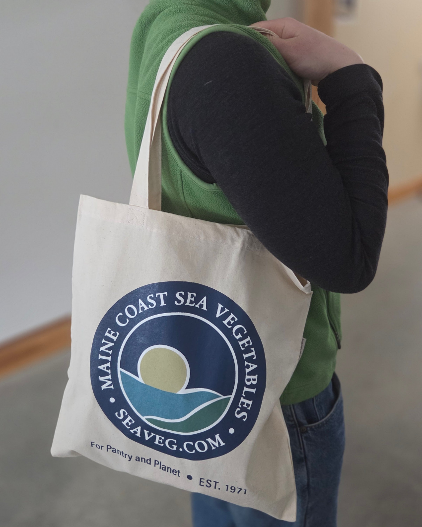 Maine Coast Sea Vegetables logo tote bag on shoulder
